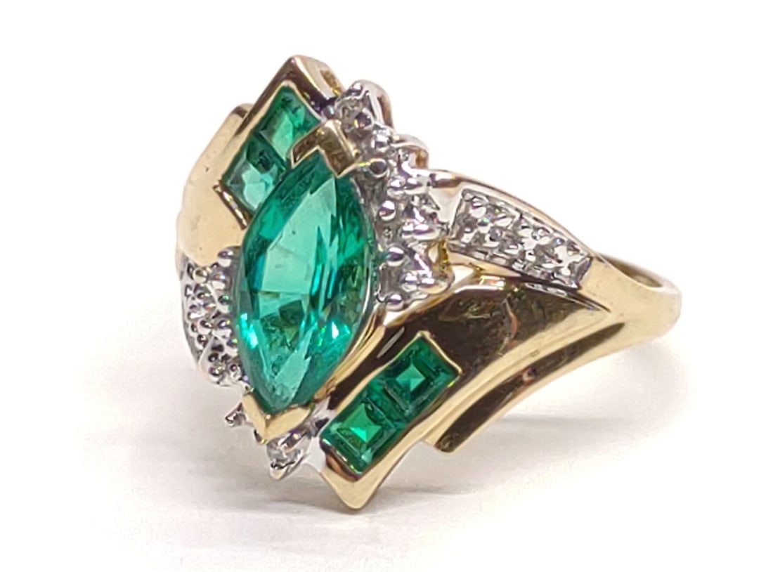10K Gold Lab Grown Emerald & Diamond Ring sz 7.25: Vintage 10 karat yellow gold statement ring with marquise lab grown emerald (5x9mm), 4 baguette lab emeralds, and 2 diamond accents. Mounted in bypass style setting. Ring size 7.25. Inner band is mark