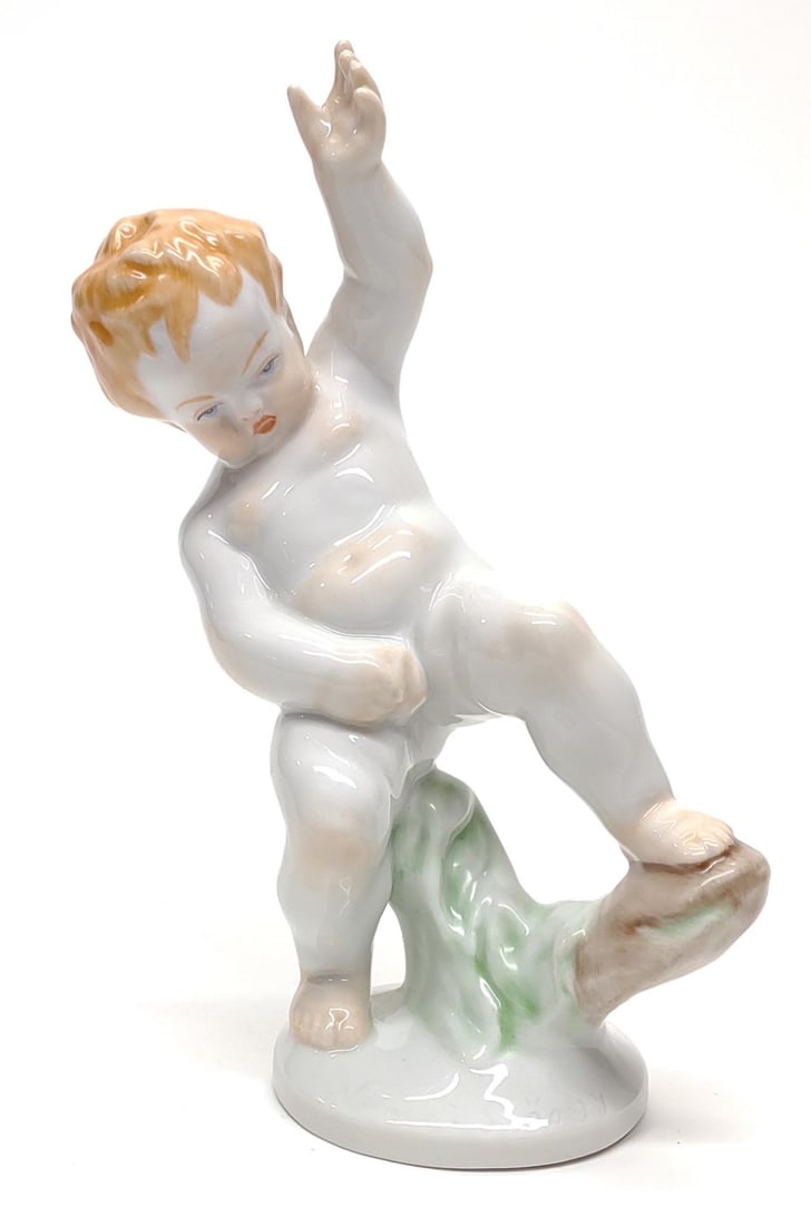 Herend #5751 Porcelain Cherub Figurine: Vintage Herend signed porcelain figure of Putti (nude cherub). Underside is marked with Herend Hungary makers mark, and 5751. No chips or cracks. Measures approx.: 7 x 5 x 2 1/2 in. SHIPPING OPTIONS A
