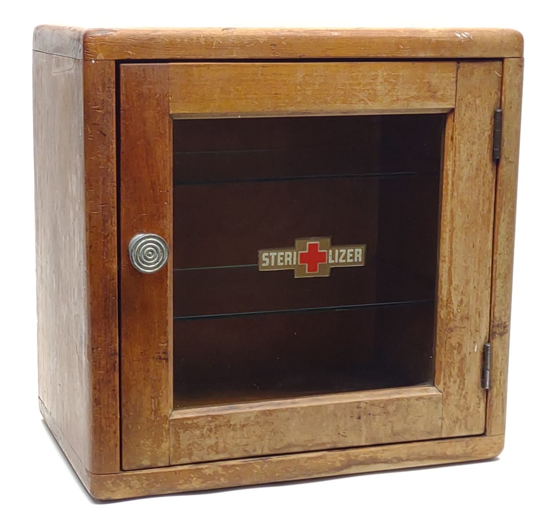 1930s Barber Shop Sterilizer Cabinet w/ 2 Shelves: Vintage, 1930s, medical / barber shop wood and glass sterilizer cabinet with two glass shelves. Front painted "Sterilizer" labeling is in very good condition. Measures approx.: 12 x 12 x 8 in. SHIPPIN