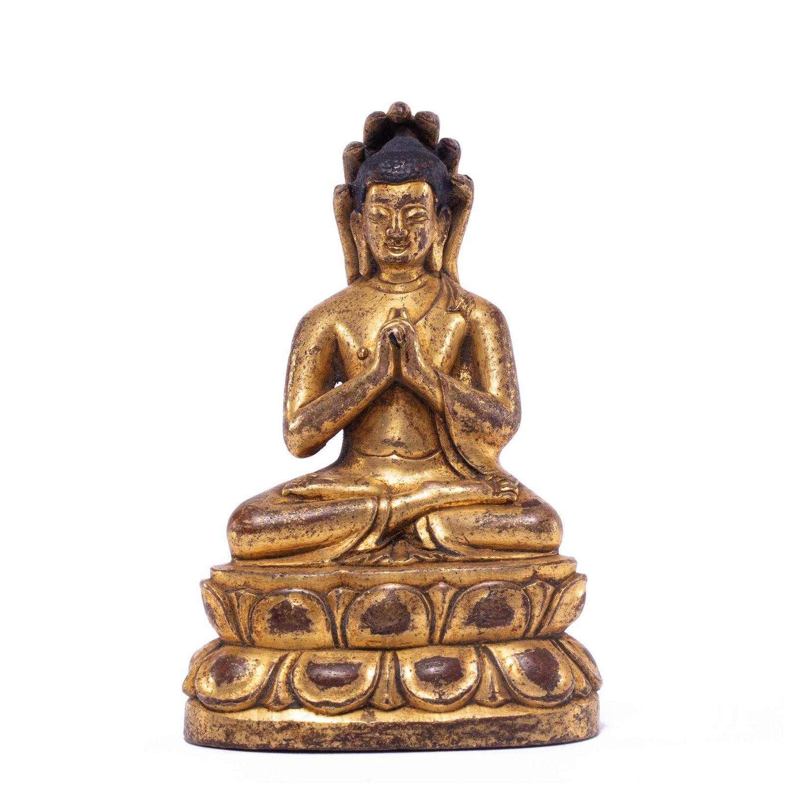 A GILT BRONZE FIGURE OF BUDDHA MAHARAJA: A BRONZE-GILT FIGURE OF BUDDHA MAHARAJA Seated in dhyanasana over a double-lotus base, his hands held together in mudra of Supreme Enlightenment, clad in a robe, the face serene with downcast eyes, wi