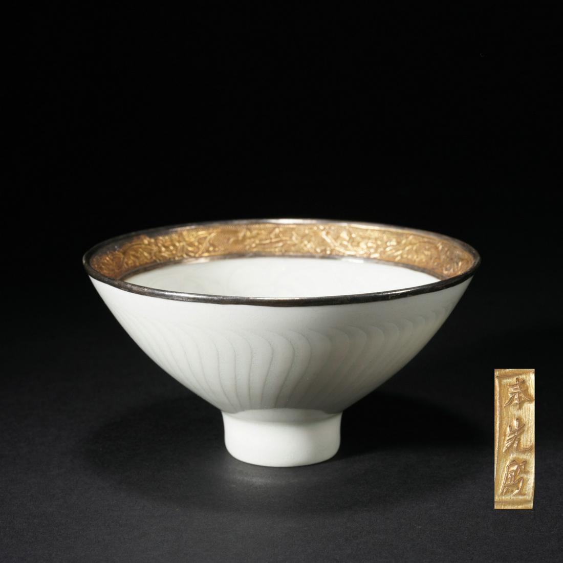 A CHINESE TING-WARE CUP: A CHINESE TING-WARE CUP The deep conical sides rising from a cylindrical foot, incised curved lines at the exterior, covered in pale glaze. DIMENSIONS: 12x6 cm. HAVE A SIMILAR ITEM TO SELL? CONTACT: I
