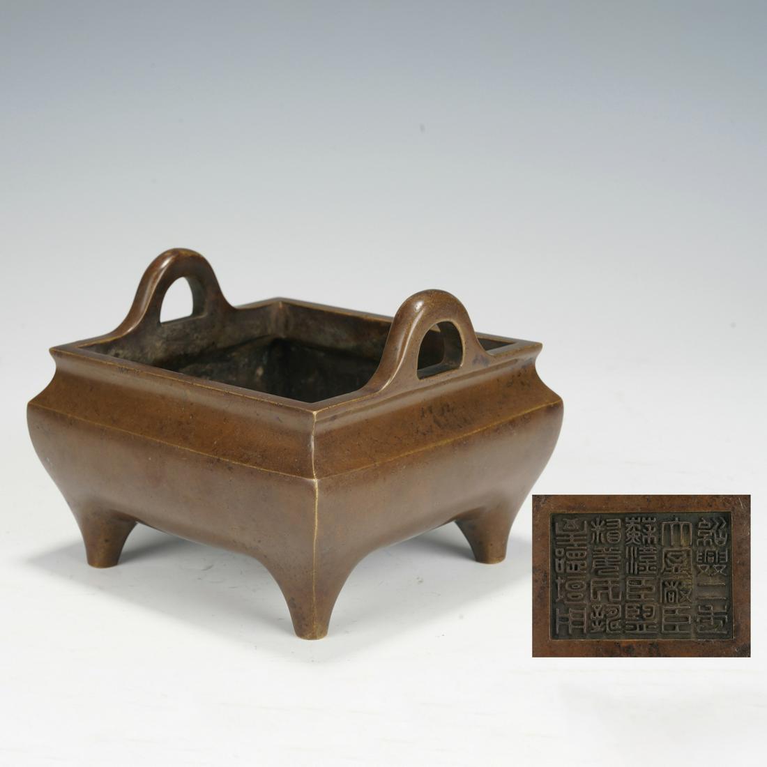 A CHINESE BRONZE RECTANGULAR CENSER: A CHINESE BRONZE RECTANGULAR CENSER The censer is raised on four legged supports and flanked by two upright curved handles. DIMENSIONS: 17x15.5x12.8 cm. Weight 3370 grams. HAVE A SIMILAR ITEM TO SELL