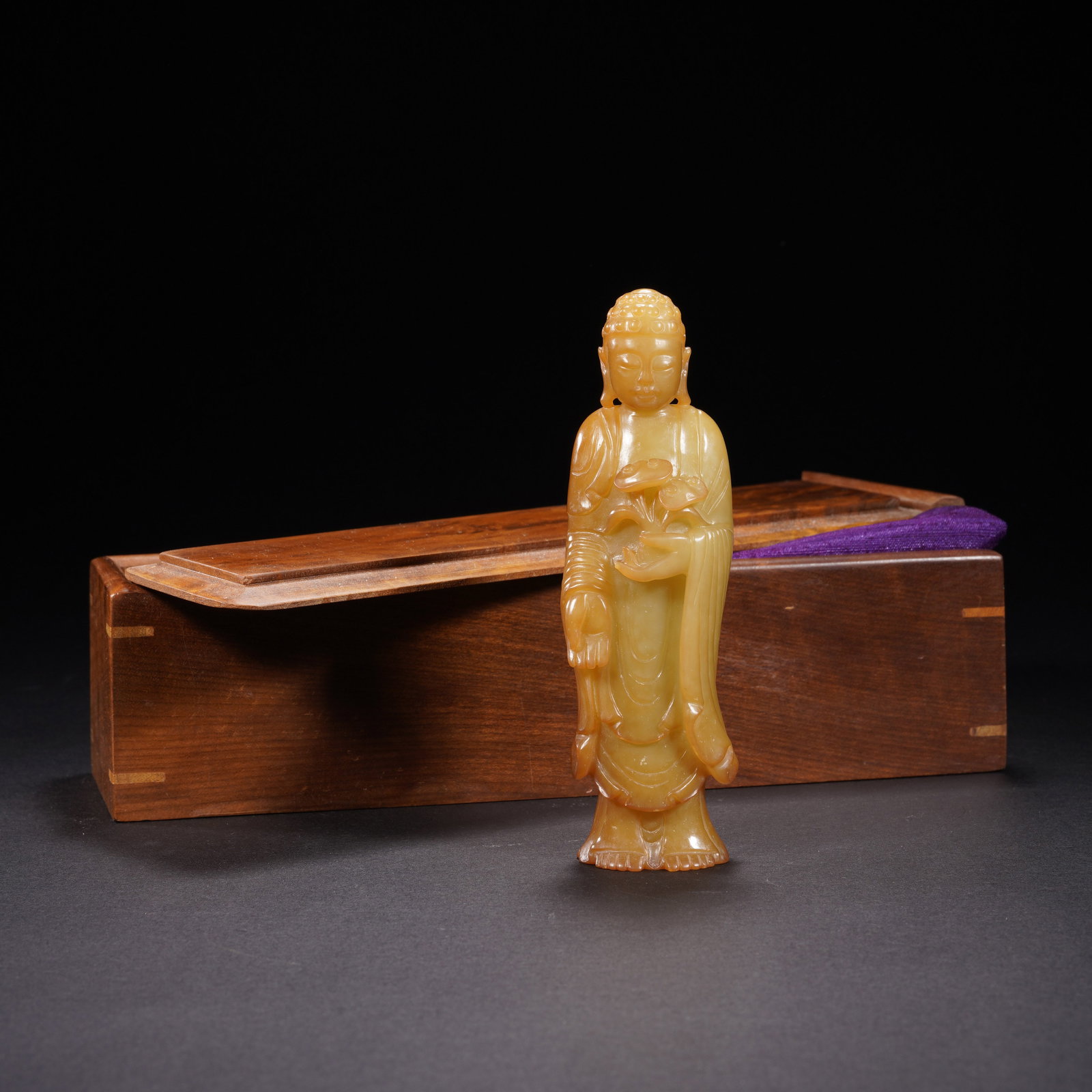A CARVED YELLOW JADE STANDING AMITABHA (1 of 10)