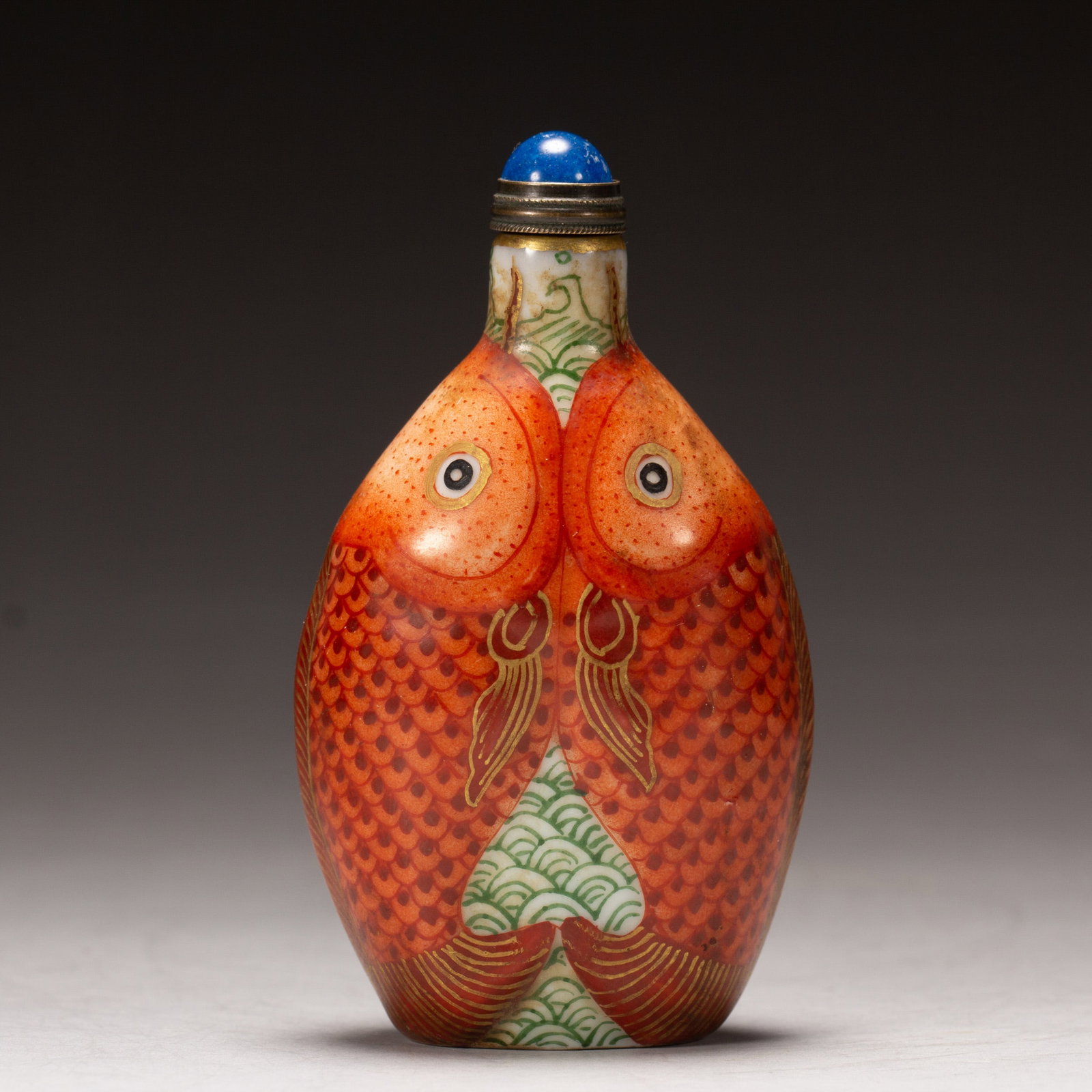 A FAMILLE ROSE MYTHICAL BEAST SNUFF BOTTLE: A FAMILLE ROSE MYTHICAL BEAST SNUFF BOTTLE Painted double fishes at the exterior, with matched stopper. DIMENSIONS: L. 4.5 cm. W. 3.5 cm. H. 7.8 cm. Weight 60 grams. HAVE A SIMILAR ITEM TO SELL? CONTA