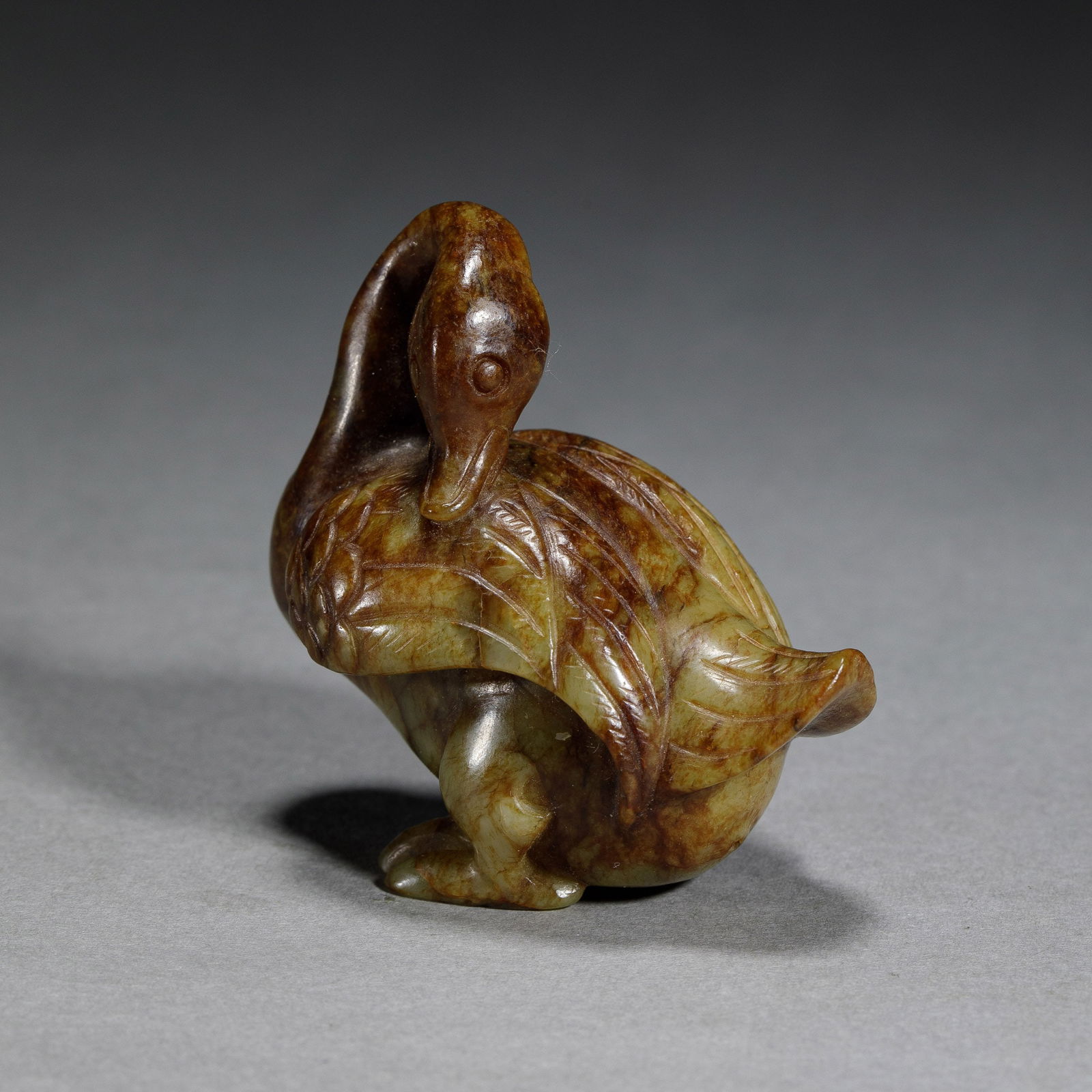 A JADE CARVING OF DUCK: A JADE CARVING OF DUCK The stone is of greenish celadon tone with russet speckles. DIMENSIONS: L. 5.5 cm. W. 3.5 cm. H. 5.5 cm. Weight 68 grams. HAVE A SIMILAR ITEM TO SELL? CONTACT: INFO@GORDONGALLER