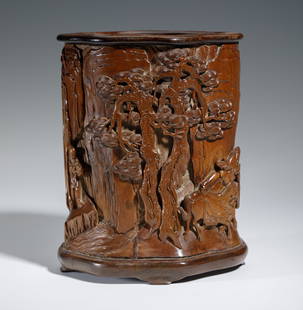 A CARVED BOXWOOD FIGURAL STORY BRUSHPOT: A CARVED BOXWOOD FIGURAL STORY BRUSHPOT Deeply carved with figure among landscape, including a continue scene of pine forest and swirling clouds, overall carved in boxwood in caramel tone. DIMENSIONS: