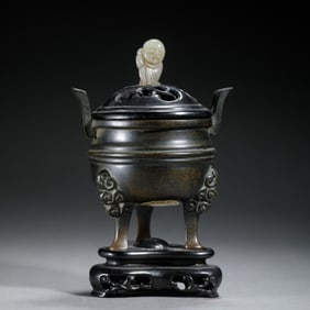A BRONZE TRIPOD CENSER WITH COVER
