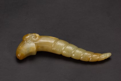 A CARVED JADE SILK WORM SHAPE PENDANT
