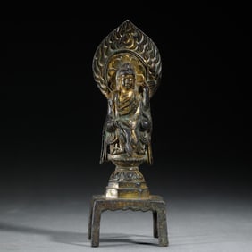 A BRONZE-GILT SEATED BUDDHA