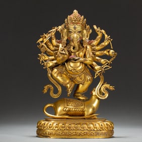 A BRONZE-GILT STANDING GANESHA