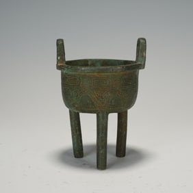 A BRONZE TRIPOD CENSER