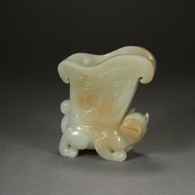 A FINE CARVED WHITE JADE MYTHICAL BEAST VESSEL