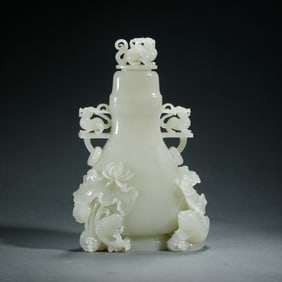 A CARVED WHITE JADE VASE WITH COVER