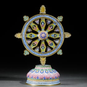 A PAINTED ENAMEL DHAMA WHEEL