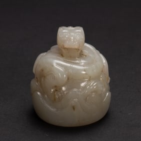 A CARVED WHITE JADE DRAGON