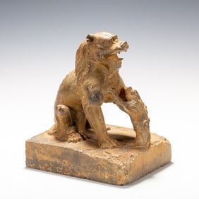 A CARVED STONE FELINE