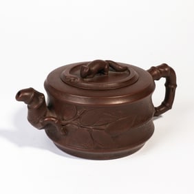 A CARVED YIXING GLAZE TEAPOT
