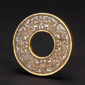A CHINESE ARCHAISTIC CARVED JADE DISC BI