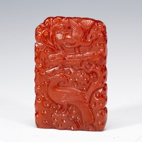 A CARVED AMBER PHOENIX PENDANT