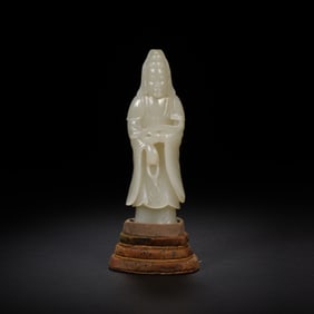 A CARVED WHITE JADE STANDING GUANYIN
