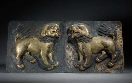 A PAIR OF GILT-BRONZE REPOUSSÉ SNOW LION PLAQUES