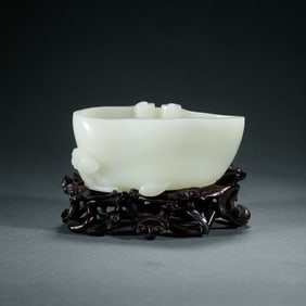 A CARVED WHITE JADE WASHER