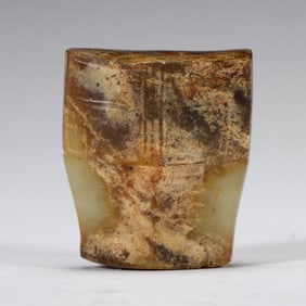A CHINESE ARCHAISTIC CARVED JADE ORNAMENT