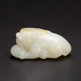 A CARVED WHITE JADE MYTHICAL BEAST