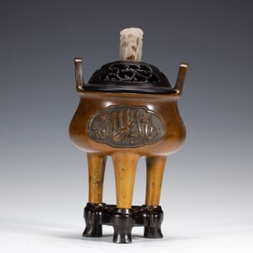A BRONZE TRIPOD CENSER WITH COVER