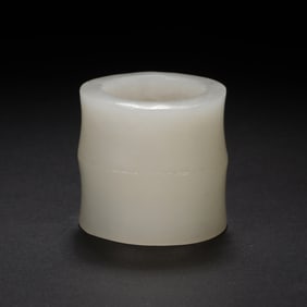 A CARVED JADE ARCHER RING