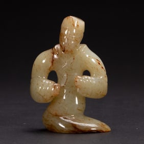 A CARVED JADE FIGURE