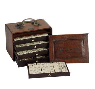 A MAHJONG SET WITH WOODEN BOX: A MAHJONG SET WITH WOODEN BOX The brass bound wood case with twin carrying handles, the slide front with five drawers fitted with bone pieces. DIMENSIONS: L. 20.5 cm. W. 14.1 cm. H. 16 cm. Weight 3015