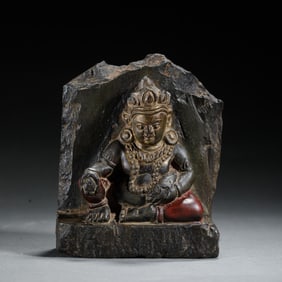 A CARVED BLACK STONE JAMBHALA