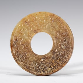 A CHINESE ARCHAISTIC CARVED JADE DISC BI