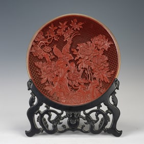 A CARVED CINNABAR LACQUER PHEASANTS AND PEONY PLATE