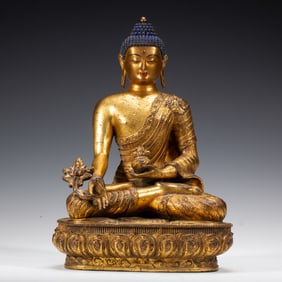 A BRONZE-GILT SEATED BUDDHA