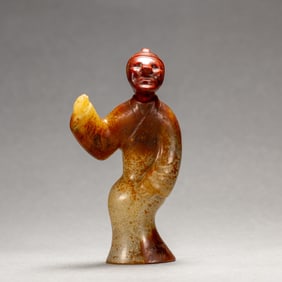 A CARVED JADE STANDING FIGURE
