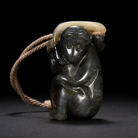 A CARVED JADE MONKEY