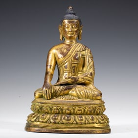 A BRONZE-GILT SEATED SHAKYAMUNI