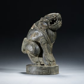 A CARVED STONE FELINE