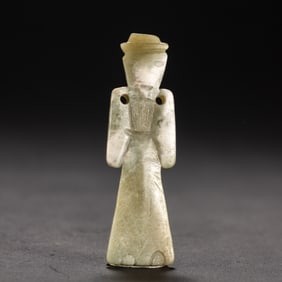 A CARVED JADE FIGURE