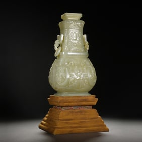 A CHINESE ARCHAISTIC CARVED JADE VASE