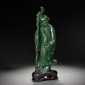 A CARVED SPINACH GREEN JADE GOD OF LONGEVITY