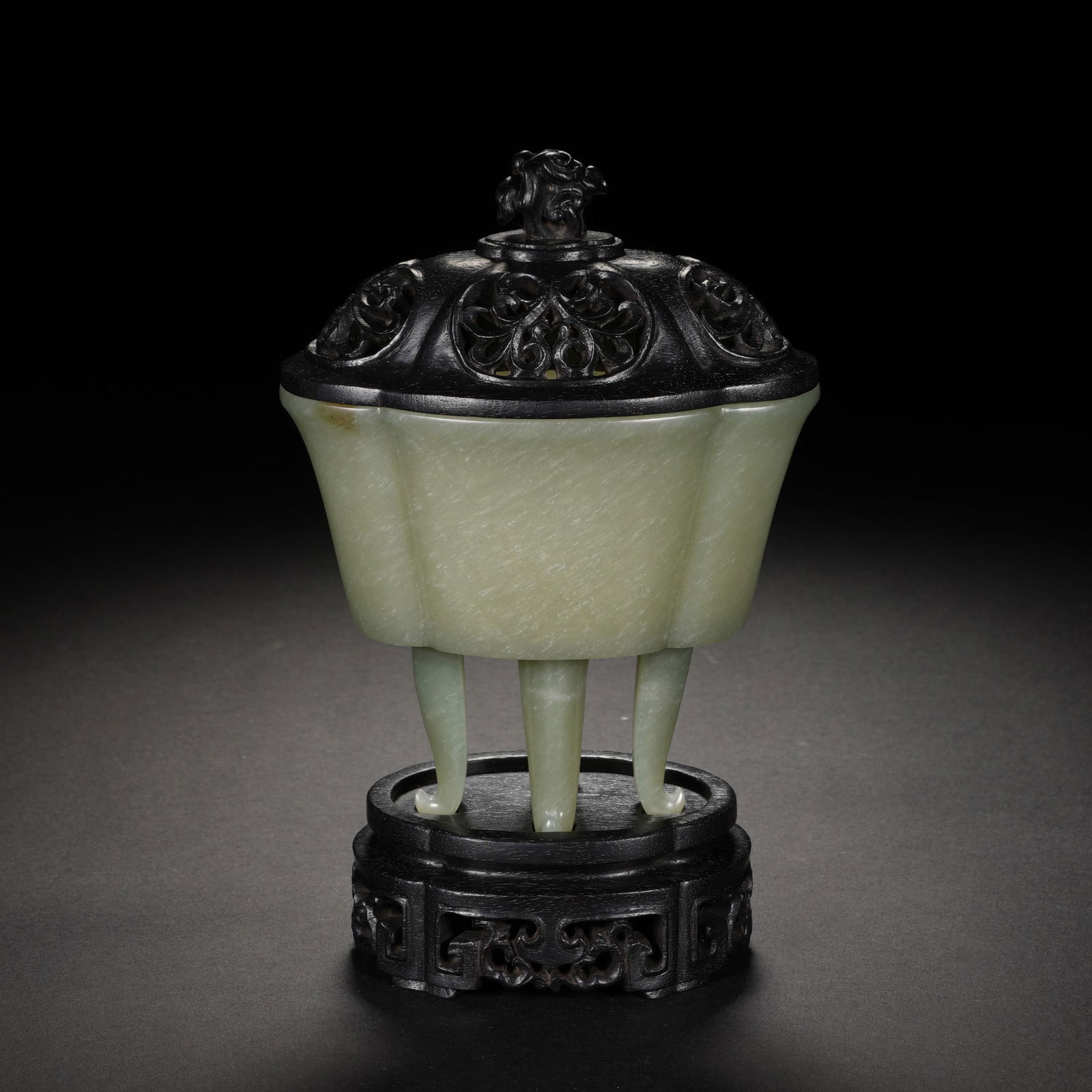 A CARVED JADE TRIPOD CENSER: A CARVED JADE TRIPOD CENSER Of begonia form, supported on three curved feet, surmounted on a carved wooden cover. DIMENSIONS: 9x6x15 cm. Weight 99 grams. HAVE A SIMILAR ITEM TO SELL? CONTACT: INFO@GOR