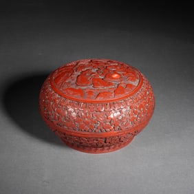 A CARVED CINNABAR LACQUER BOX WITH COVER