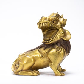 A BRONZE-GILT LION