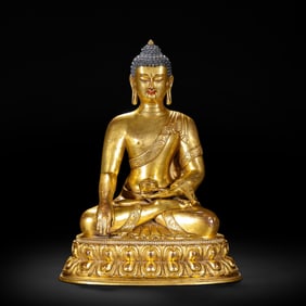 A BRONZE-GILT FIGURE OF SHAKYAMUNI