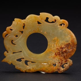 A CARVED JADE ORNAMENT SHE