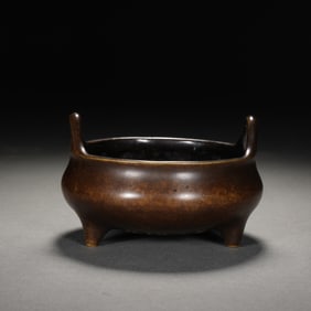 A BRONZE TRIPOD CENSER
