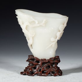 A CARVED WHITE JADE LIBATION CUP